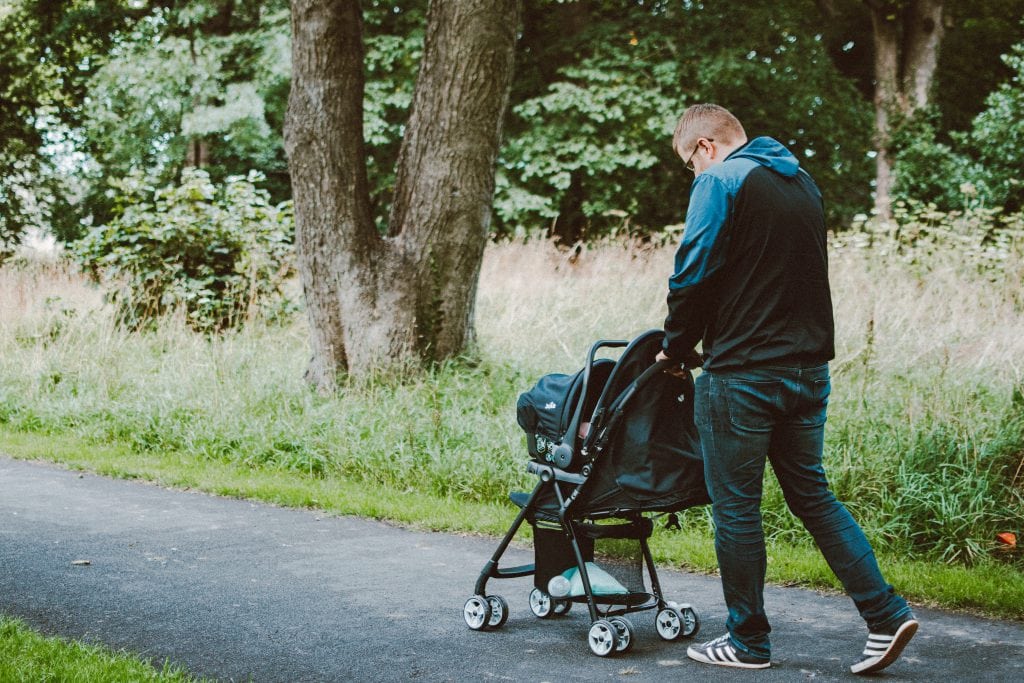 photo-of-man-pushing-baby-on-stroller-on-permeable-pavement-2815694